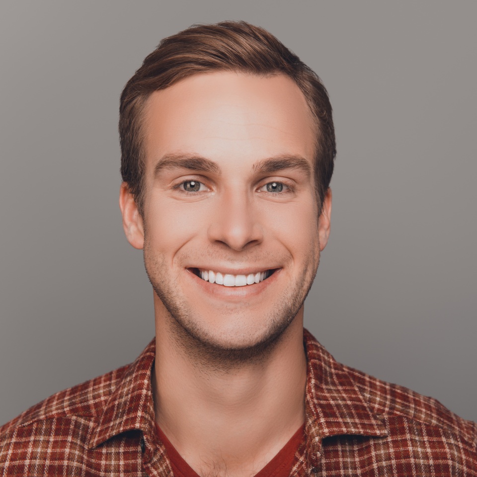 Close up photo of happy young man with beaming smile