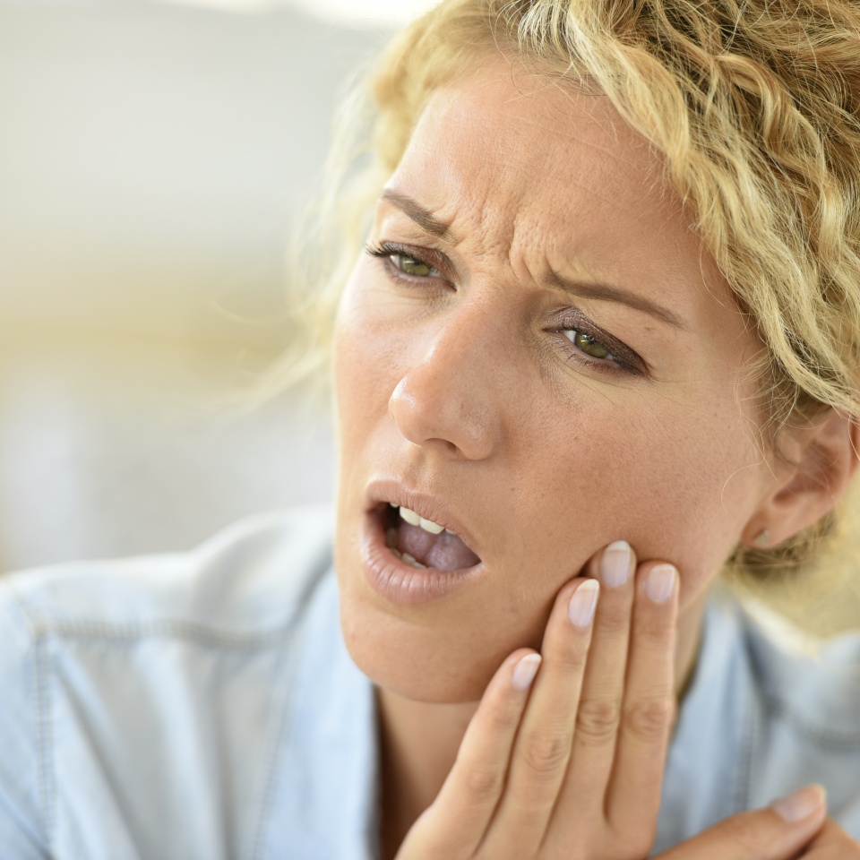 Middle-aged woman suffering toothache
