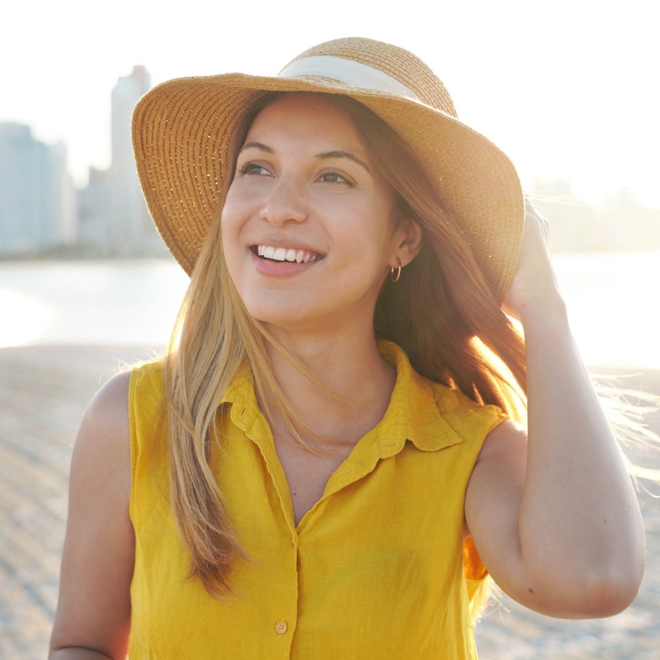 Portrait of beautiful young lady with spontaneous smile looking to the side. Authentic people enjoying life outdoor.